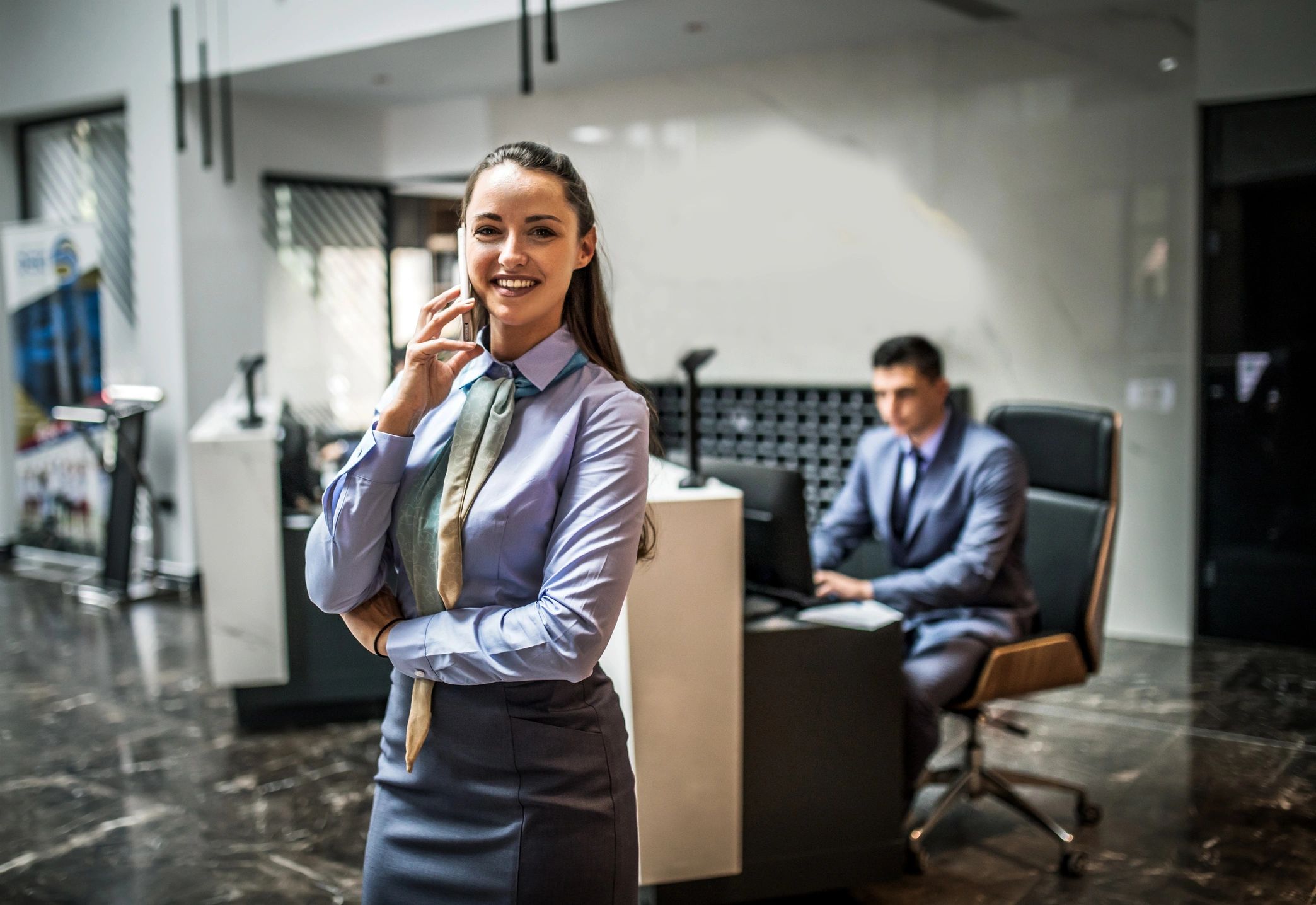 Hotel receptionist assisting a guest at the front desk