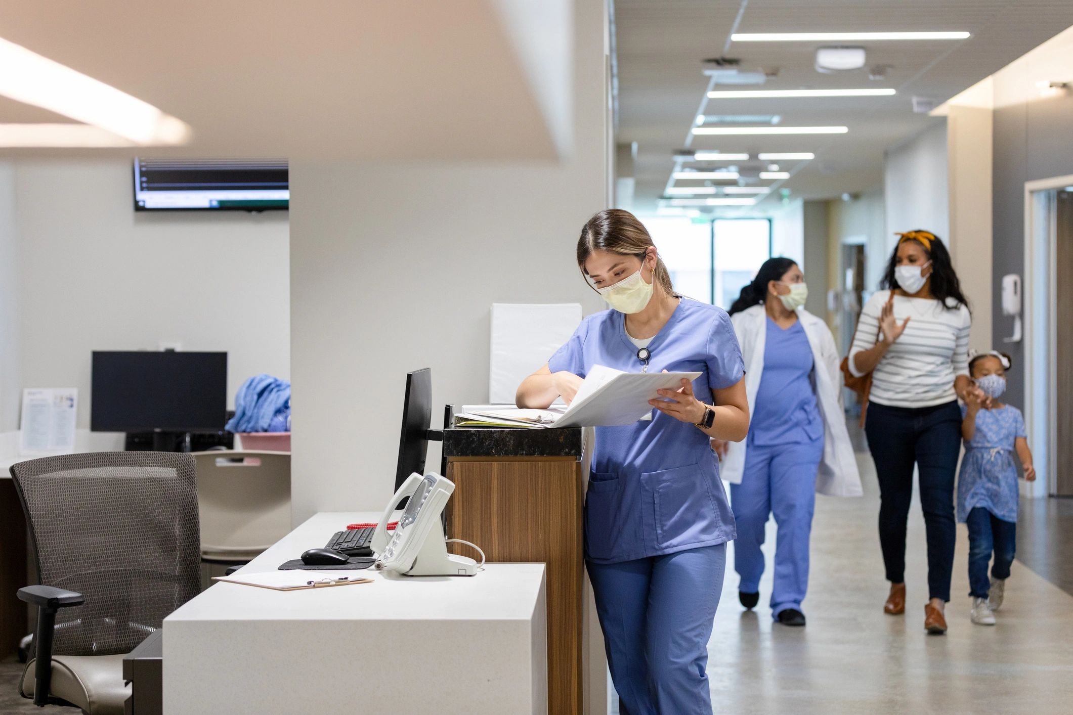 Healthcare professional walking with a patient in a hospital