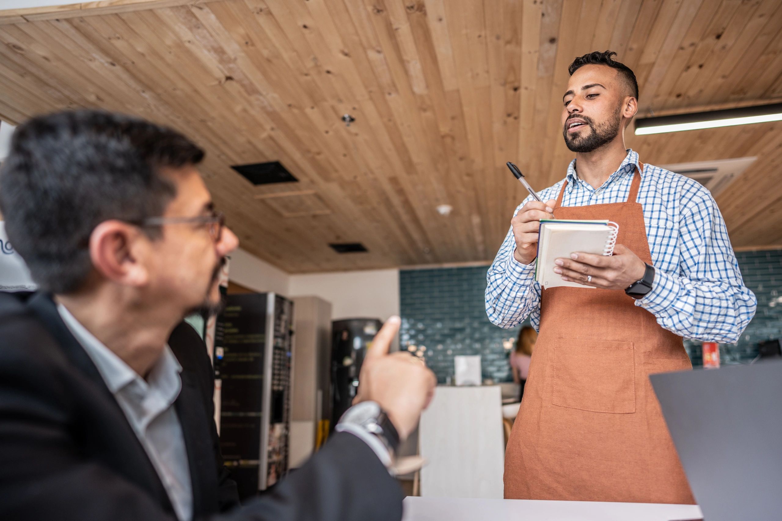 Waiter serving a customer at a cafe