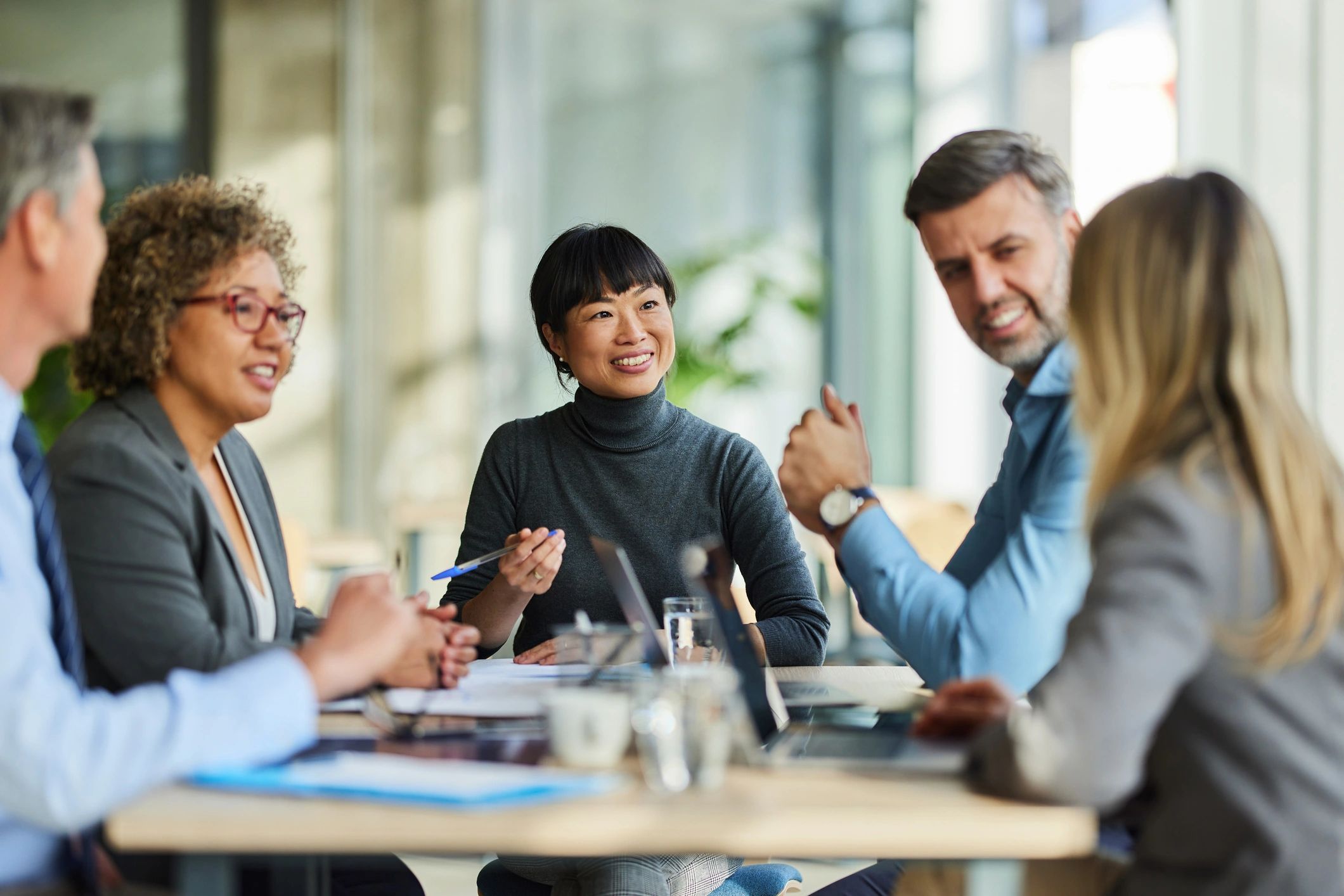 Professional staffing team meeting in an office