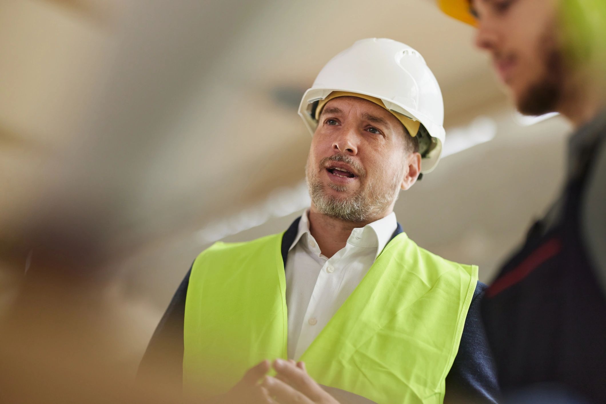 Construction supervisor reviewing plans on an active job site