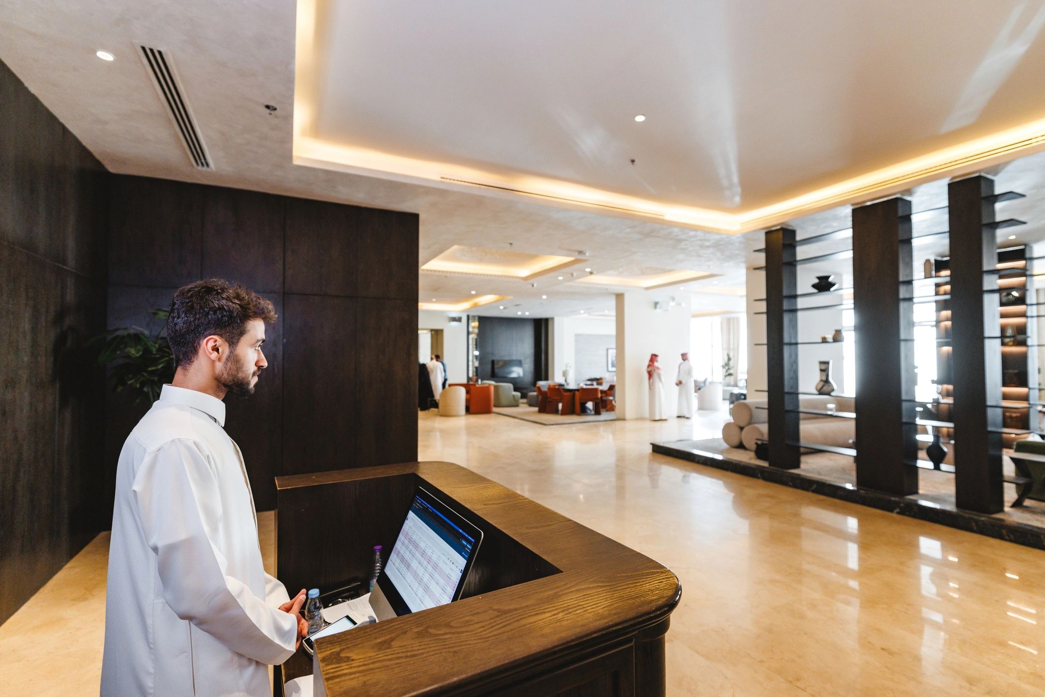 Professional at a lobby desk representing front-of-house coverage