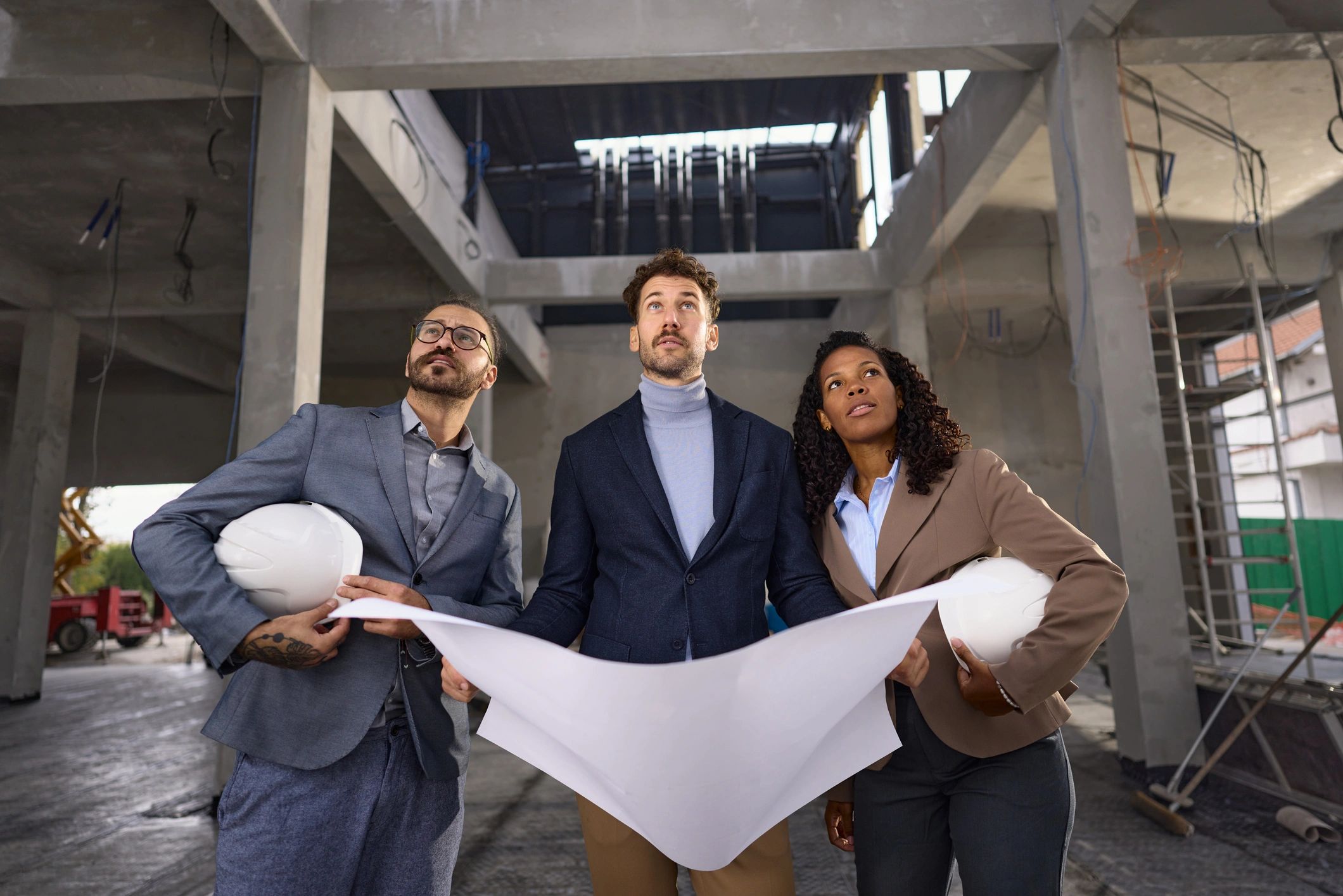 Contractors reviewing blueprints on site